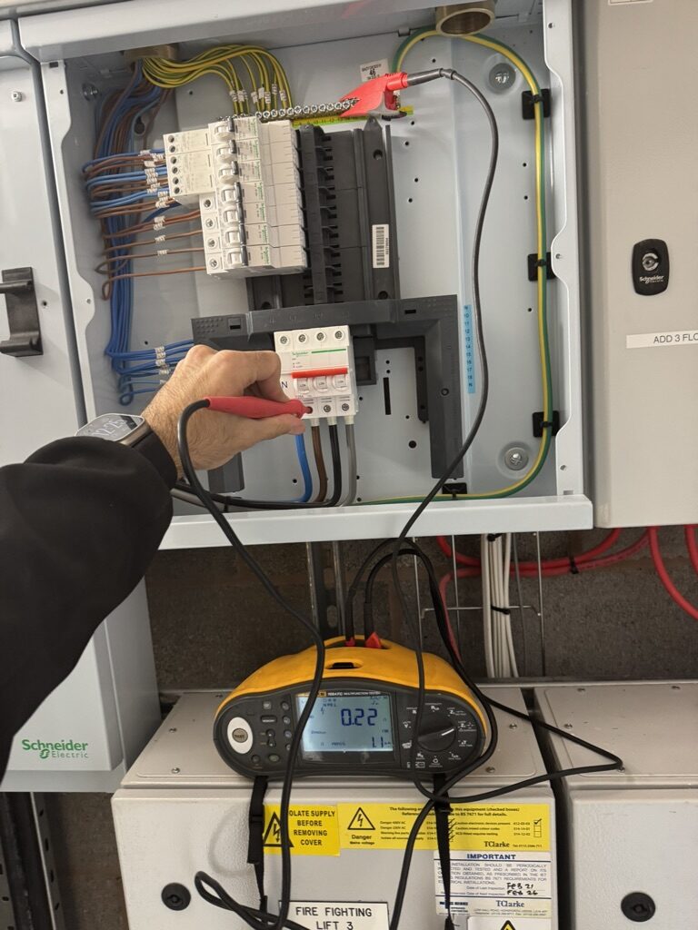 Electro Sure electrician live testing a distribution board with a calibrated multifunction tester